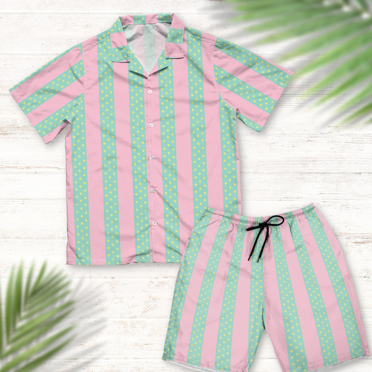 A detailed view of a Ken Beach Suit Outfit inspired by the Barbie movie. The set includes a green and pink Hawaiian shirt with a beach-themed pattern and matching shorts. The shirt showcases a button-up design with a relaxed fit, while the shorts have an elastic waistband for comfort.