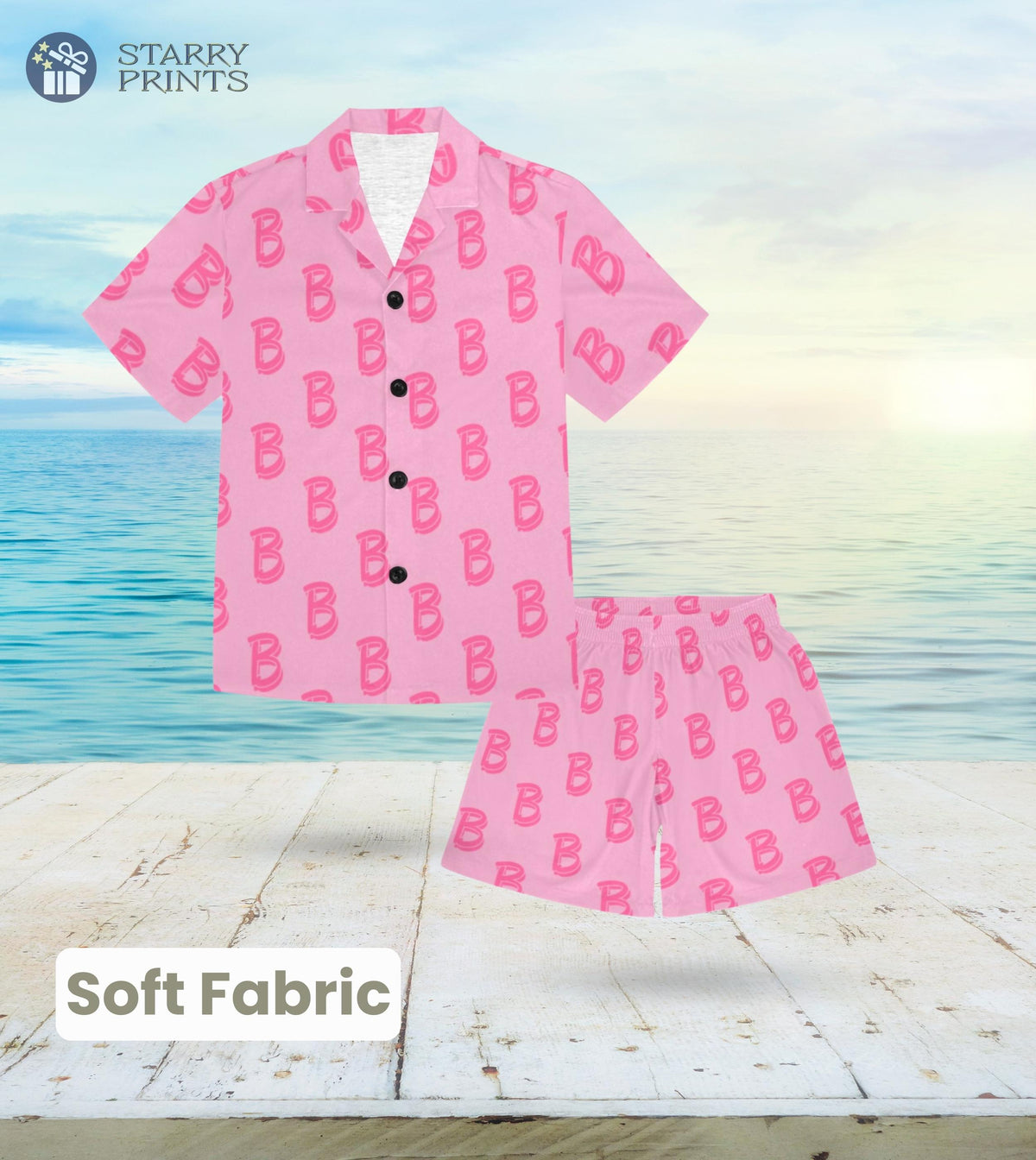 A toddler's pajama set featuring a pink top with the letter 'B' printed in a large font, paired with matching pink shorts. The design is inspired by Barbie's Ken, offering a playful and vibrant look for young kids.