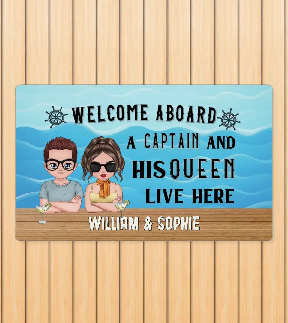Customizable 'Welcome Aboard A Captain And His Queen Live Here' doormat featuring personalized chibi characters. Ideal for yacht, boat, pontoon, ship, or cruise owners, this unique maritime-themed doormat, available in multiple colors, adds a fun and charming touch to your seafaring lifestyle. Perfect as a gift for seafaring couples or new boat owners, this durable, heat-resistant mat is a stylish addition to any maritime decor, sold by StarryPrints
