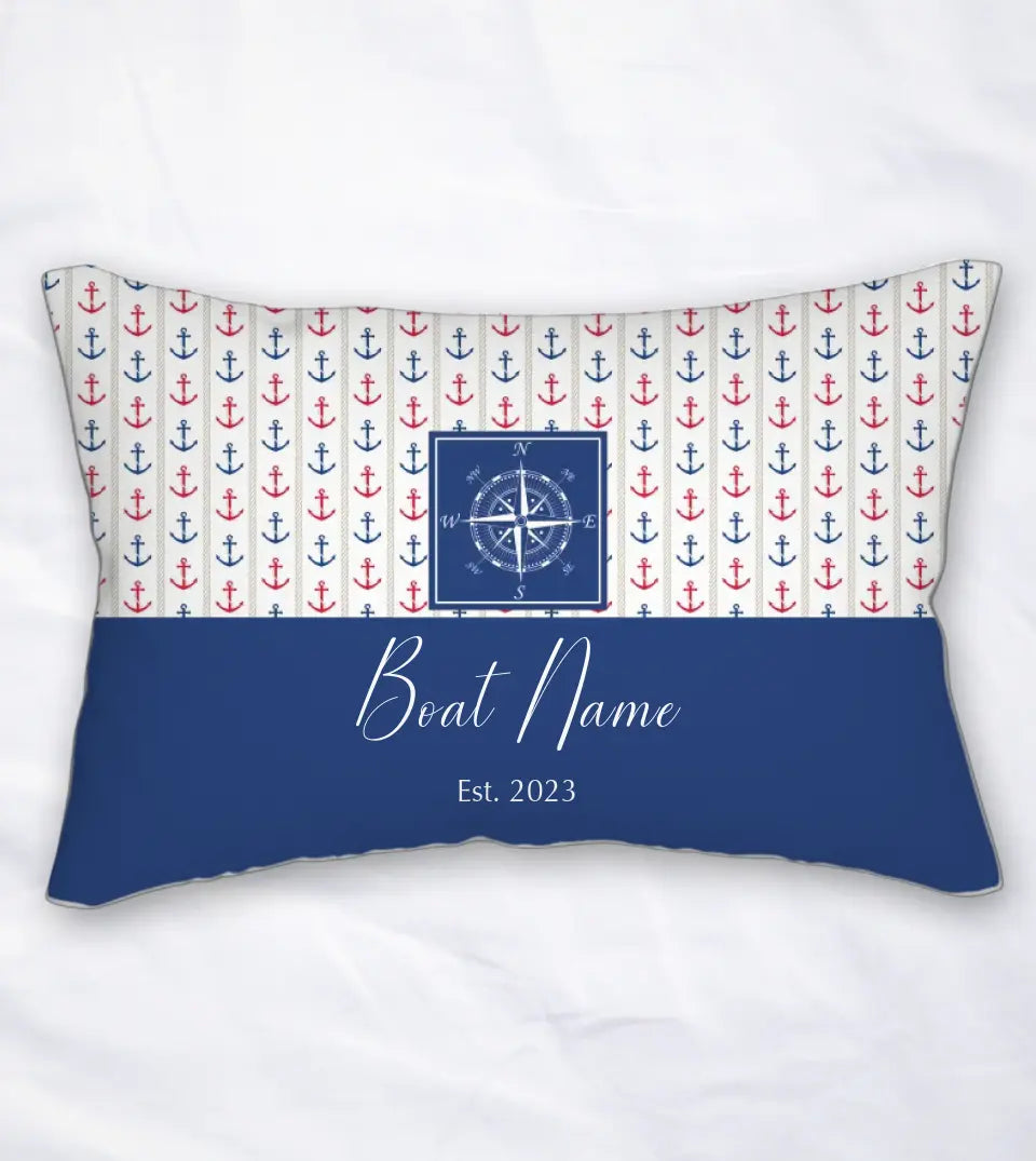 A rectangular lumbar pillow with a nautical theme, personalized with a custom boat name. The pillow features a navy blue background with a white anchor and rope design. The boat name is printed in bold white letters at the center. This comfortable maritime decor item, perfect for yacht, boat, pontoon, ship, or cruise owners, is available in a variety of nautical patterns and is sold by StarryPrints