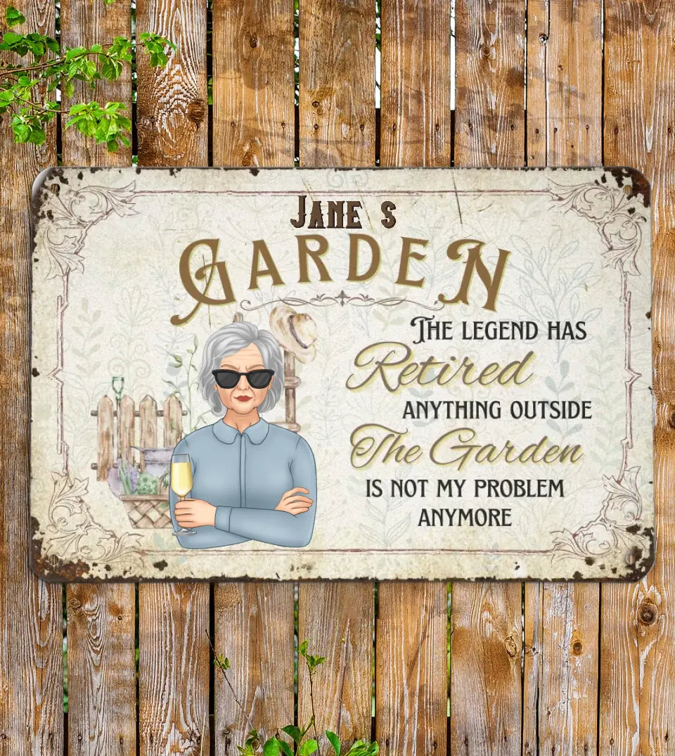Personalized aluminum garden sign with the humorous quote 'The legend has retired, anything outside the garden is not my business anymore' printed in bold, black letters against a white background, symbolizing a retiree's dedication to their garden