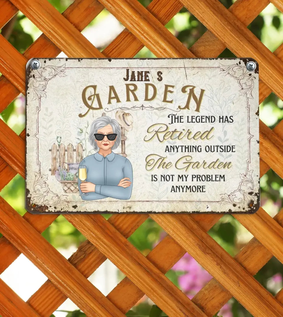 Personalized aluminum garden sign with the humorous quote 'The legend has retired, anything outside the garden is not my business anymore' printed in bold, black letters against a white background, symbolizing a retiree's dedication to their garden