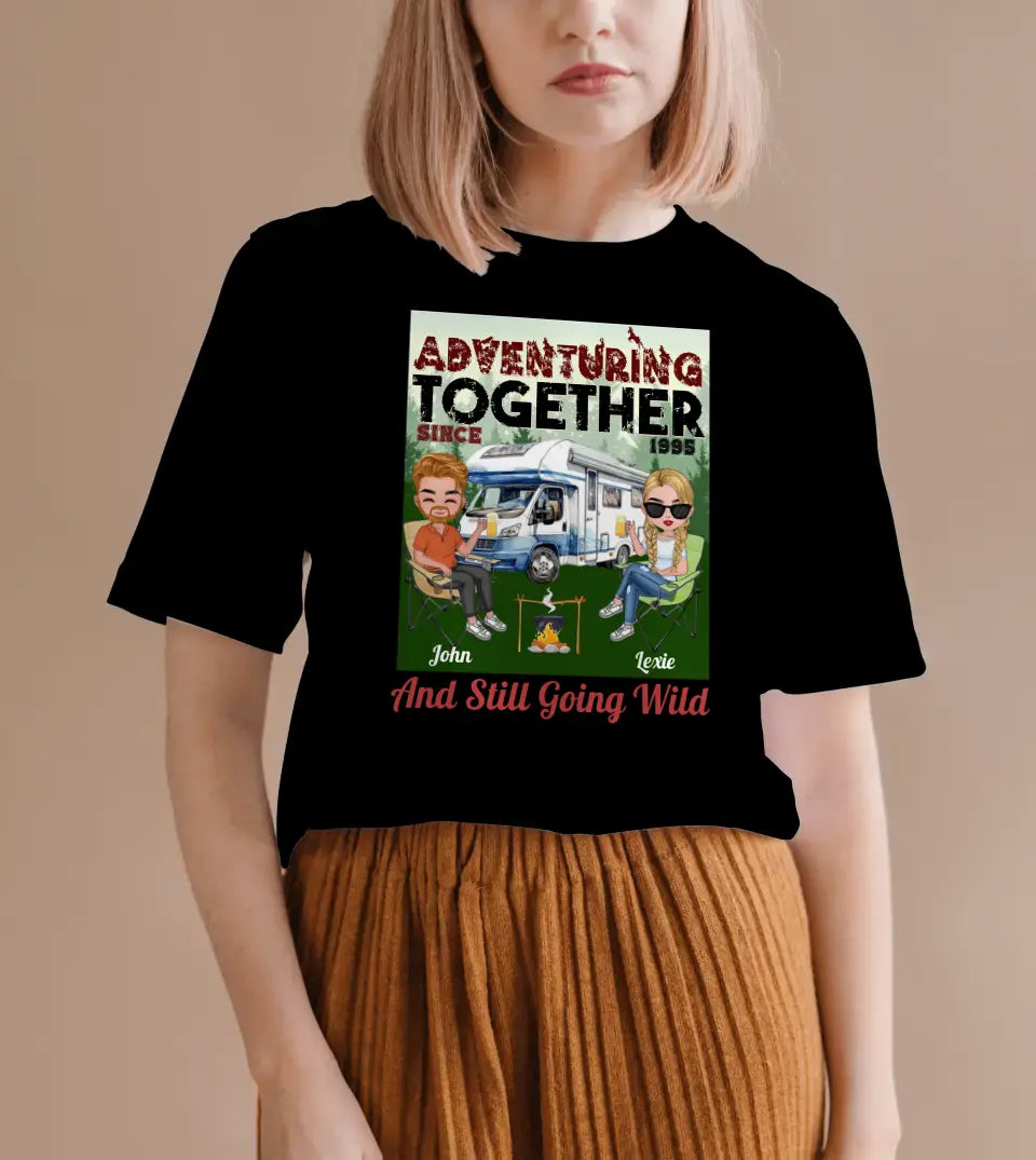 A personalized camping couple t-shirt/sweatshirt from StarryPrints. The design features two chibi characters adventuring together in a camping setting. This unique and custom piece is perfect for couples who love camping and outdoor adventures.