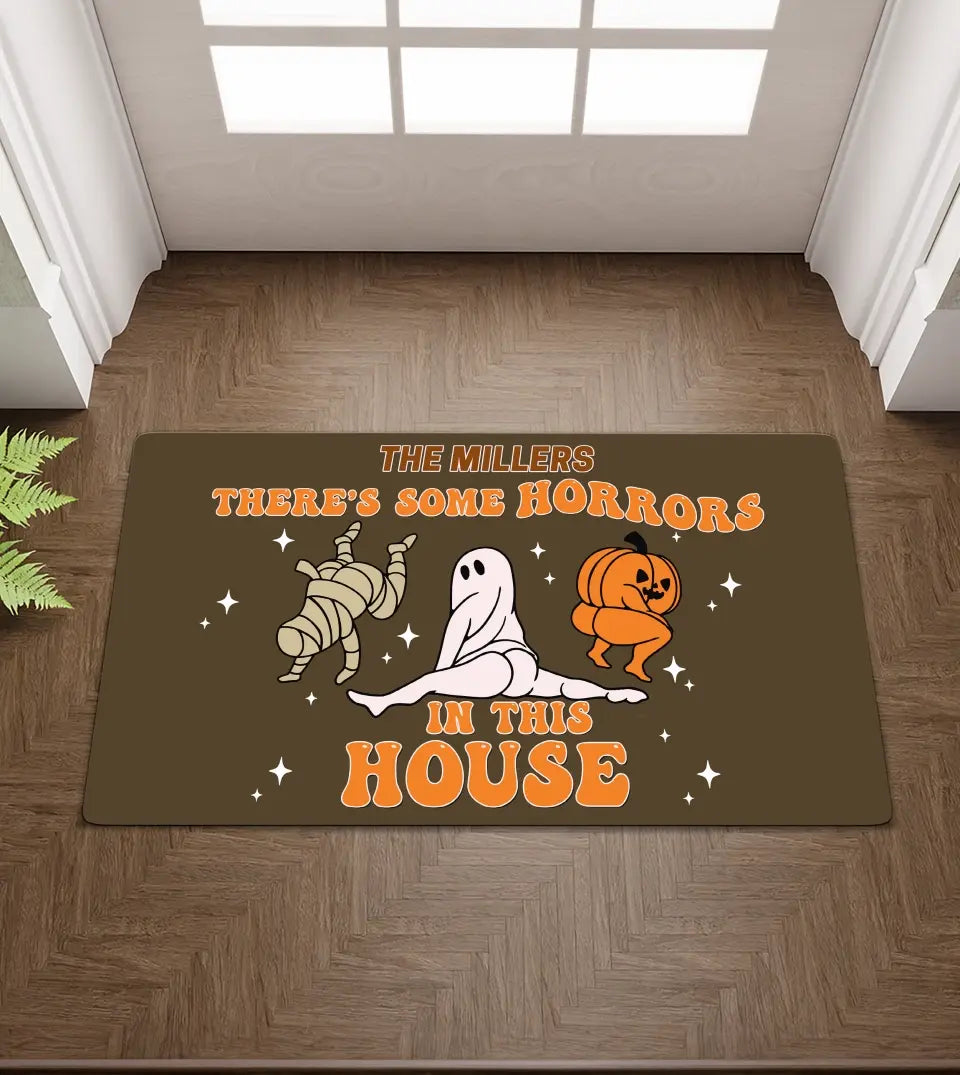Customizable doormat featuring the humorous quote 'There's Some Horrors In This House', inspired by Cardi B's song, with space for a personalized name at the top.