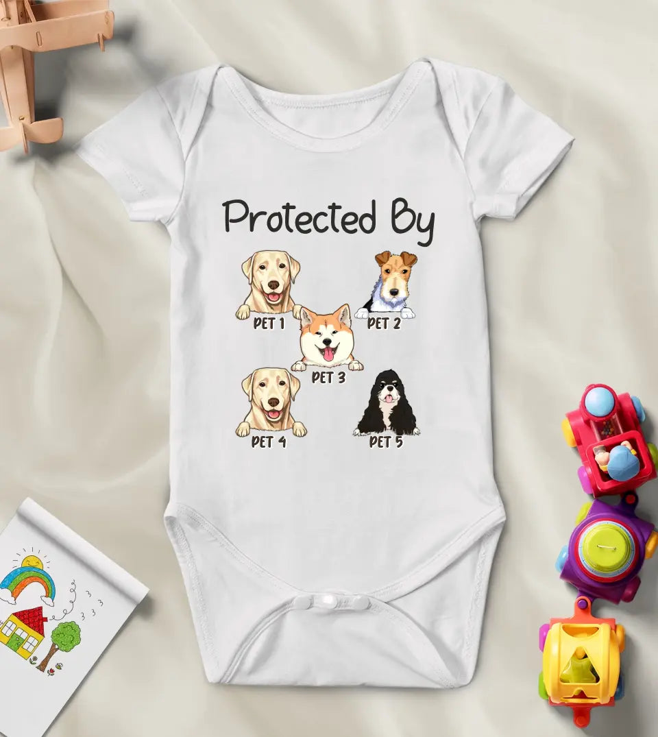 A white baby onesie with a quote "Protected by" followed by a portrait of a dog or cat and their name printed on it.